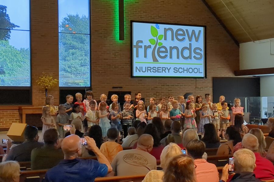 Preschoolers singing on stage at the New Friends Nursery School graduation