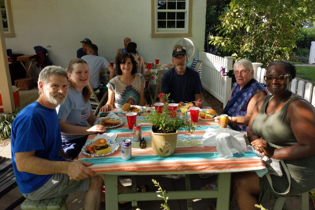 Adults sharing a meal together at a summer party