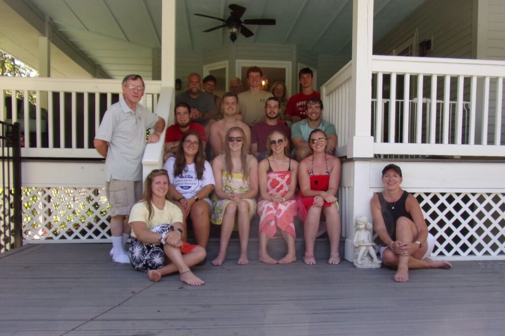 The young adults group together on a porch at their beach retreat